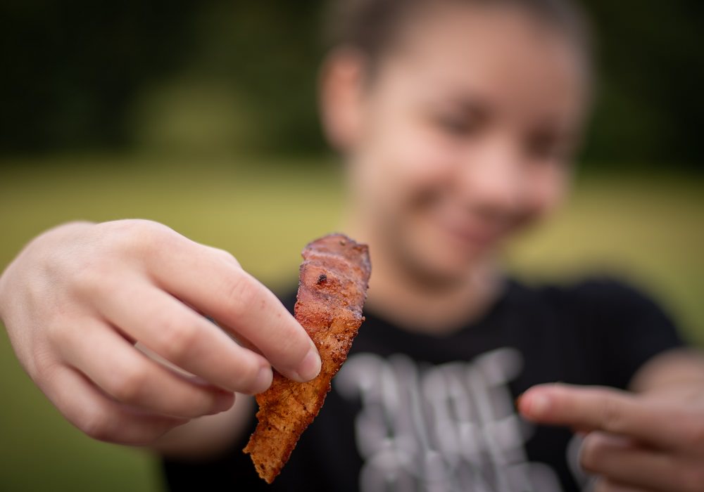 Caitlyn holding bacon pig candy