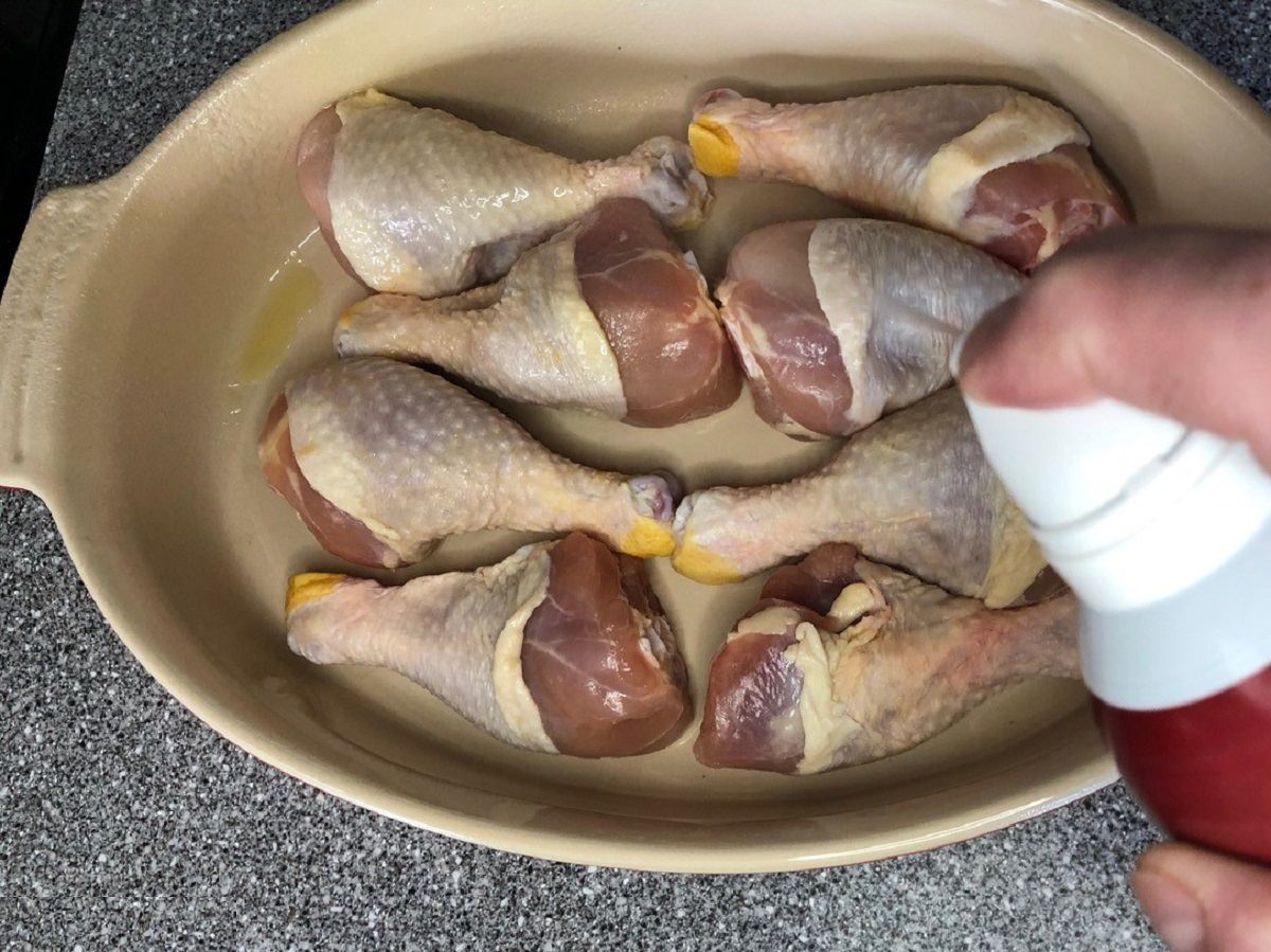 Spray the chicken legs all over with duck fat or olive oil spray