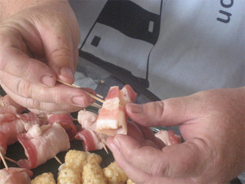 Wrap bacon around tater tots and secure bacon with toothpicks