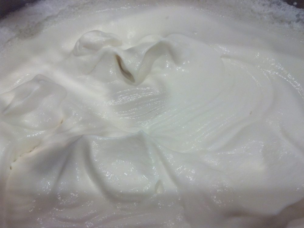 Whip cream and rum until soft peaks form