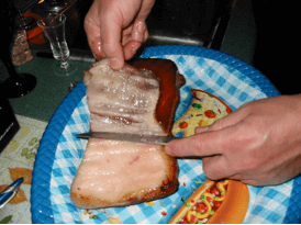 Carefully slice belly bacon