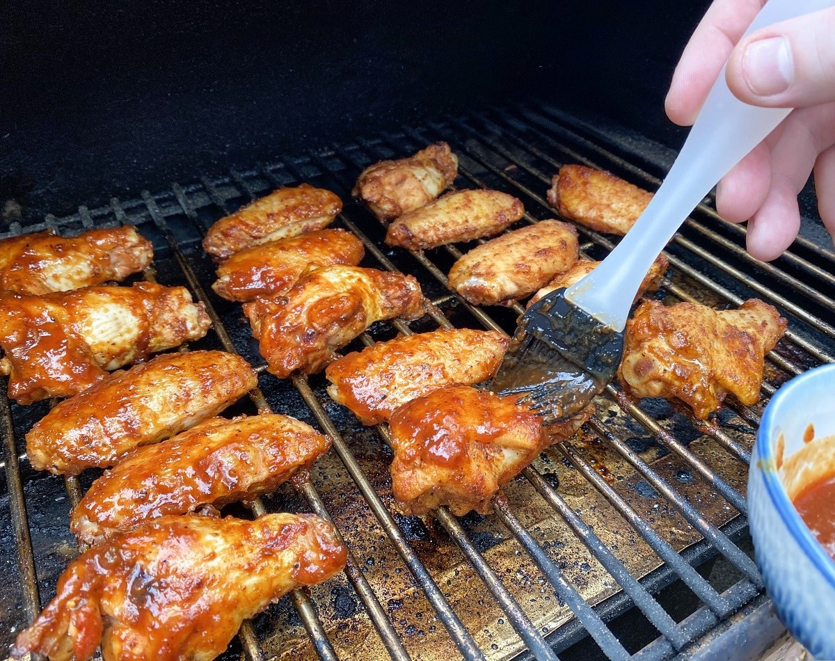 Grill chicken wings and occasionally flip and sauce