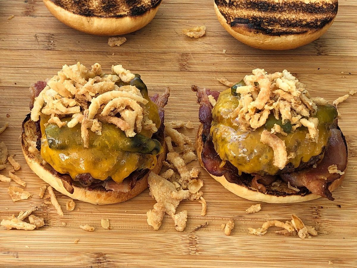 Top burgers with a handful of the crispy onions