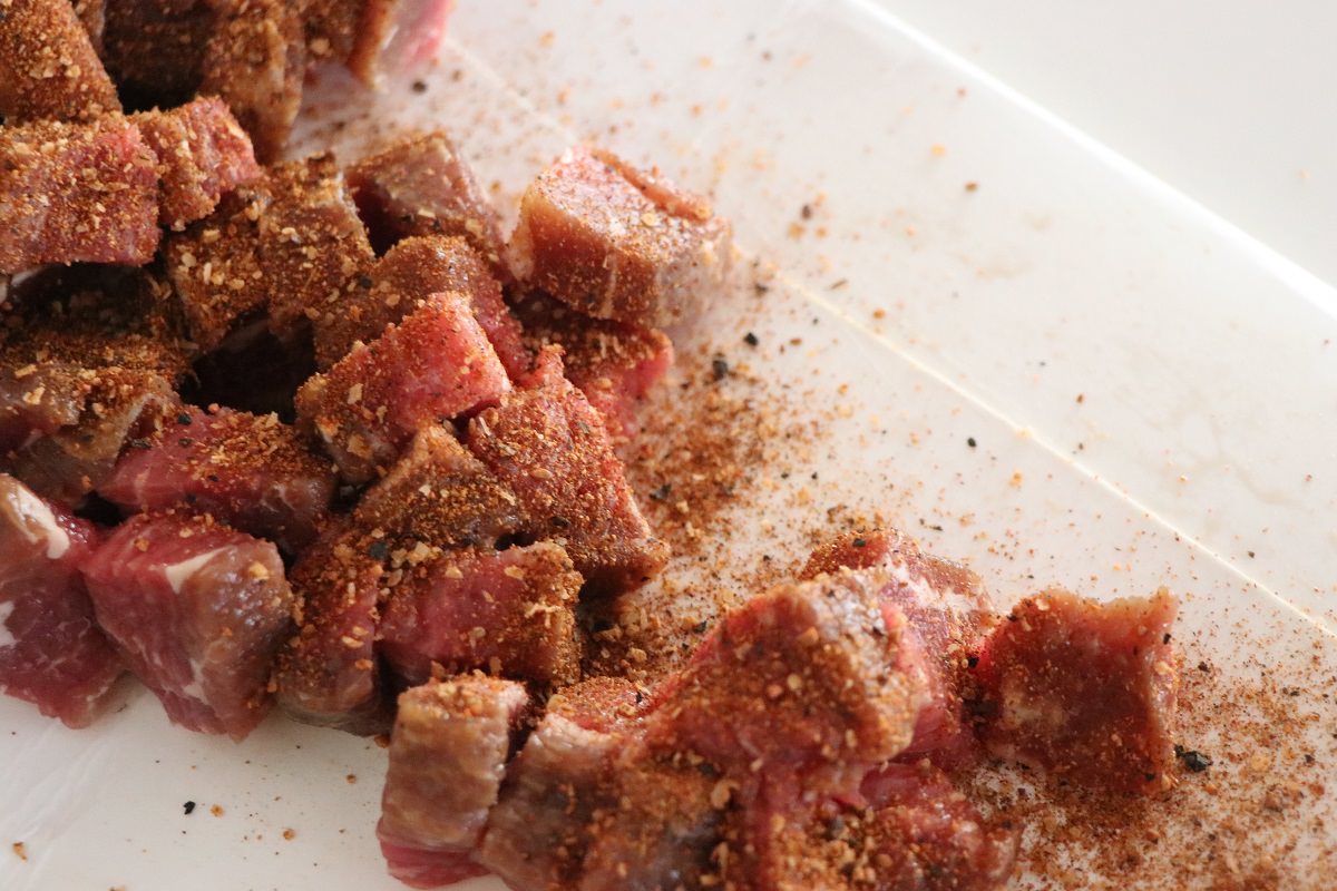 Season beef cubes with Cow Lick