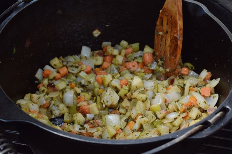 Sauté the mixture of herbs, vegetables, apples, and seasonings until soft