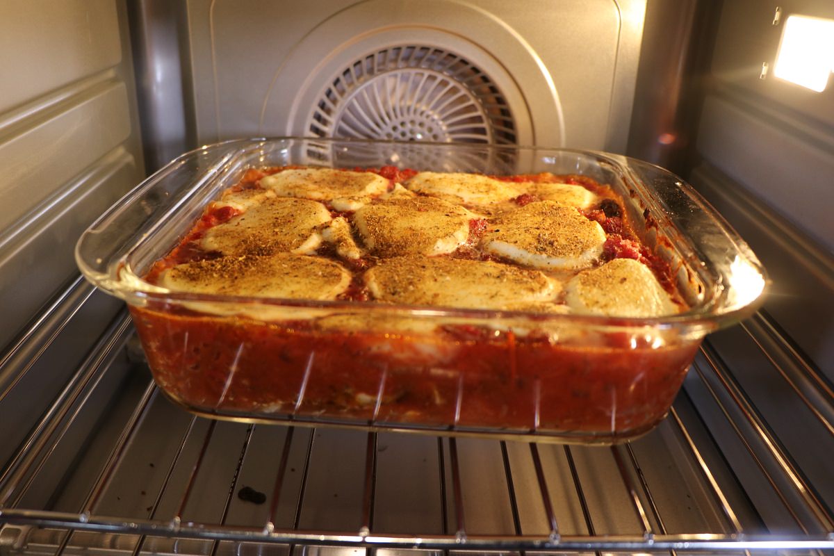 Bake in oven until cheese is melted and beginning to brown, and sauce is bubbling, approximately 40 minutes