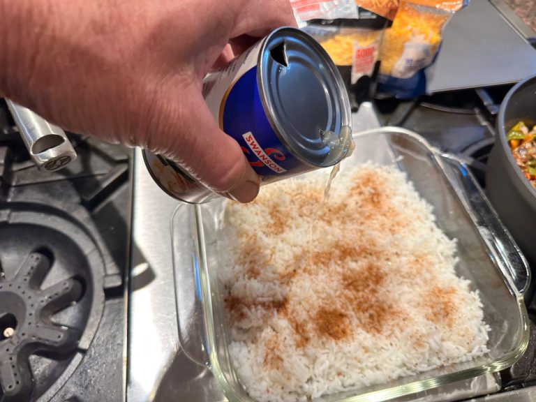 Drizzle chicken broth evenly over the rice