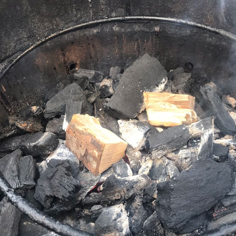 Add dry wood chunks directly on hot coals