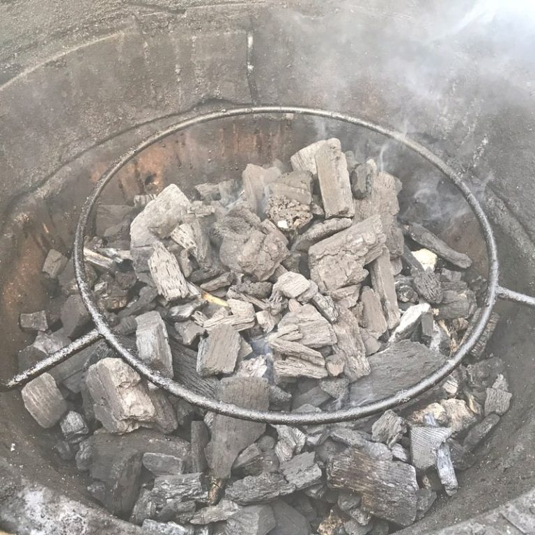 Cover burning coals/wood chunks with fresh charcoal