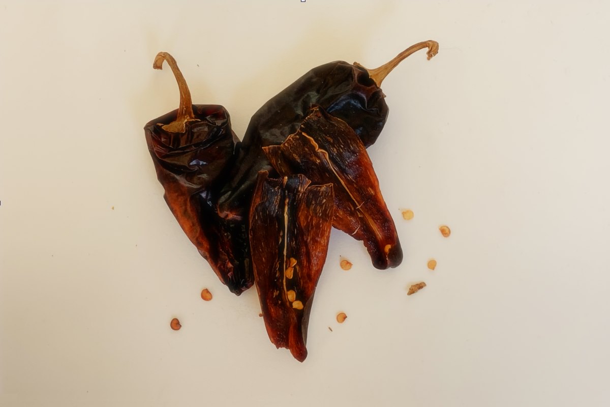 Cut Pasilla chiles open and remove seeds