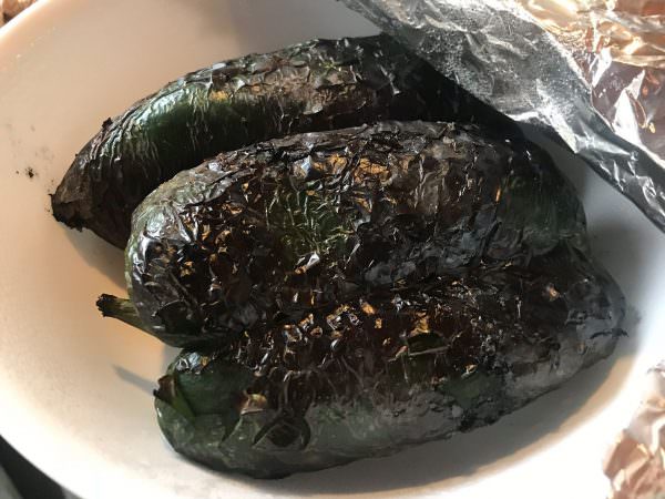 Place charred peppers in covered bowl to steam and cool