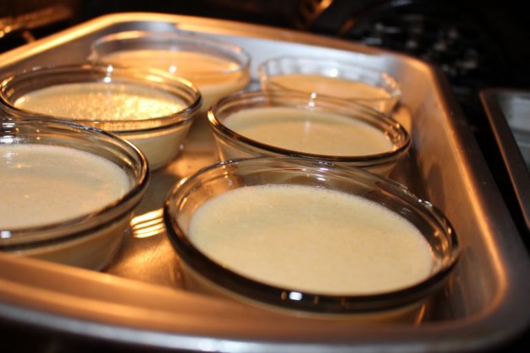 Place ramekins into a large roasting pan and add hot water