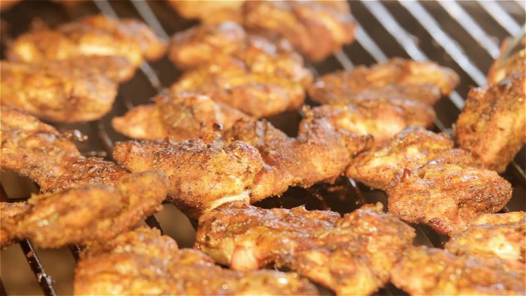 Grill seasoned chicken over medium hot fire until well browned