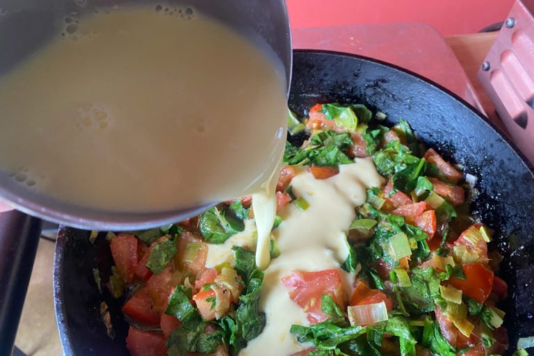 Pour egg mixture over veggies