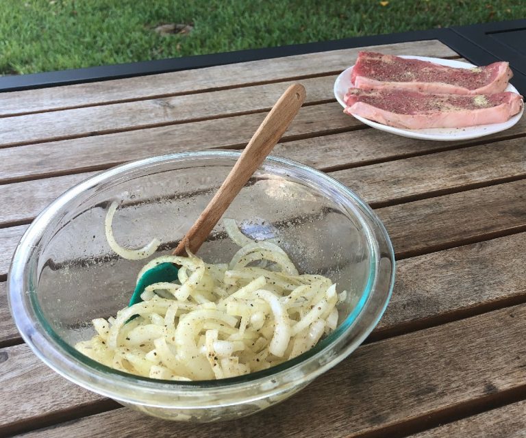 Season onion and steaks with SPG Garlic