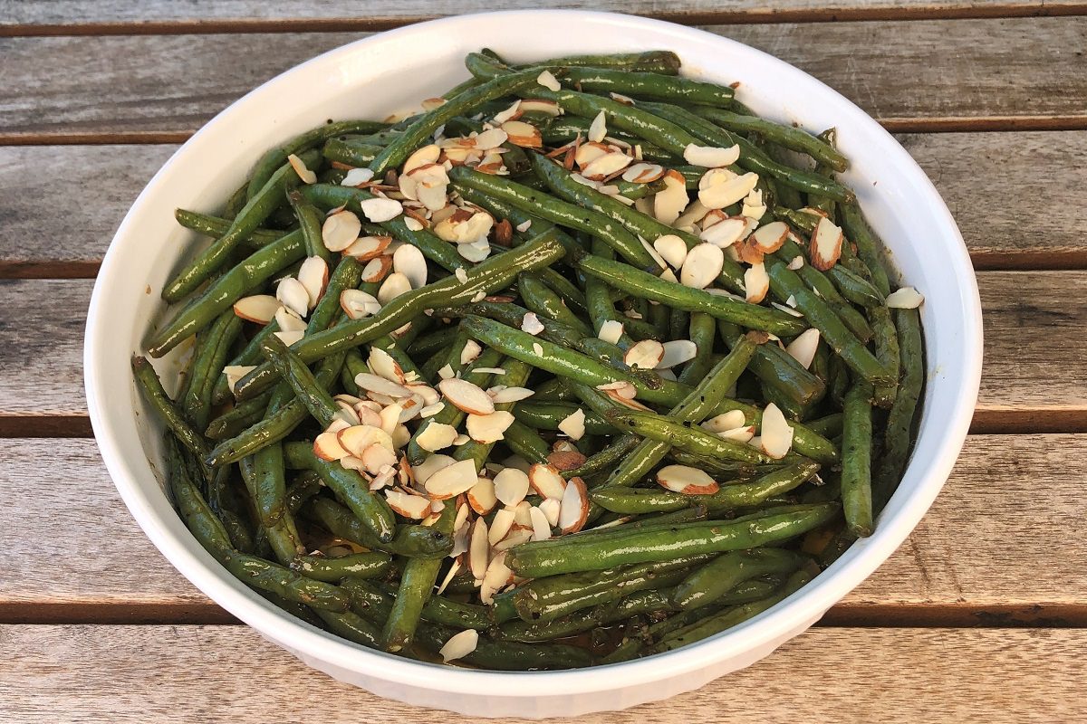 Sprinkle almonds over the green beans