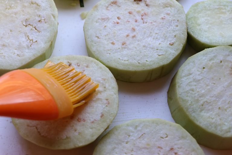 Brush or toss the eggplant rounds with olive oil