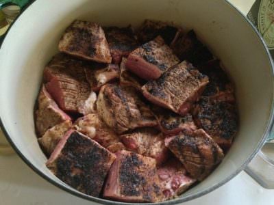 Layer brisket cubes in Dutch oven and cover with Guinness Stout
