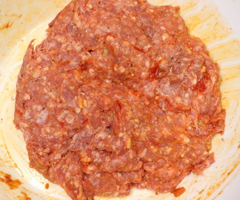 Combine ground lamb, harissa, and Happy Nancy seasoning