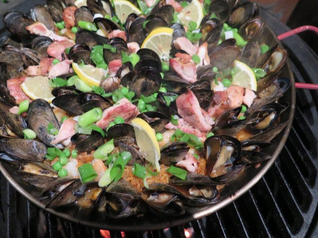 When mussels open, top with peas and scallions