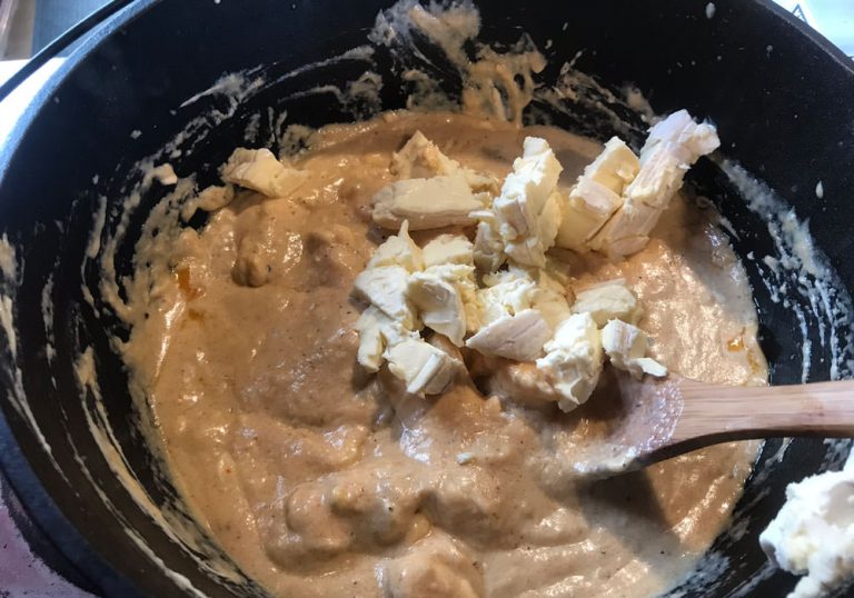 Reduce heat to medium. Slowly add cubed brie and cream cheese. Use wooden spoon from this point on