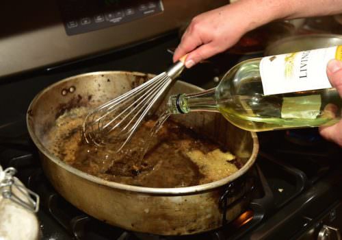 Add the wine to the roux