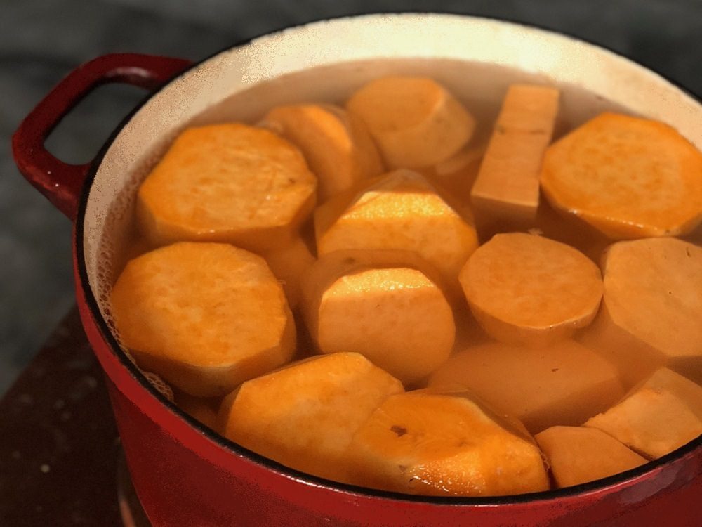 Peel sweet potatoes, cut into quarters, and boil until fork-tender