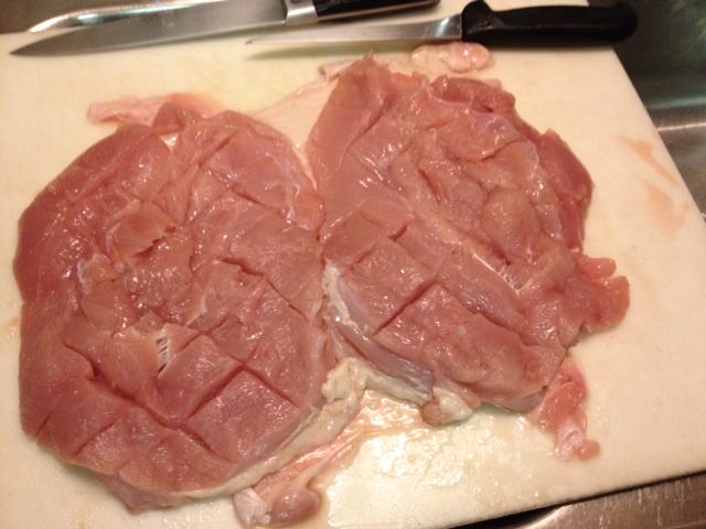 Score the breasts, being careful not to cut fully through them