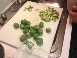 Cut off the small hard ends of Brussels sprouts and quarter them