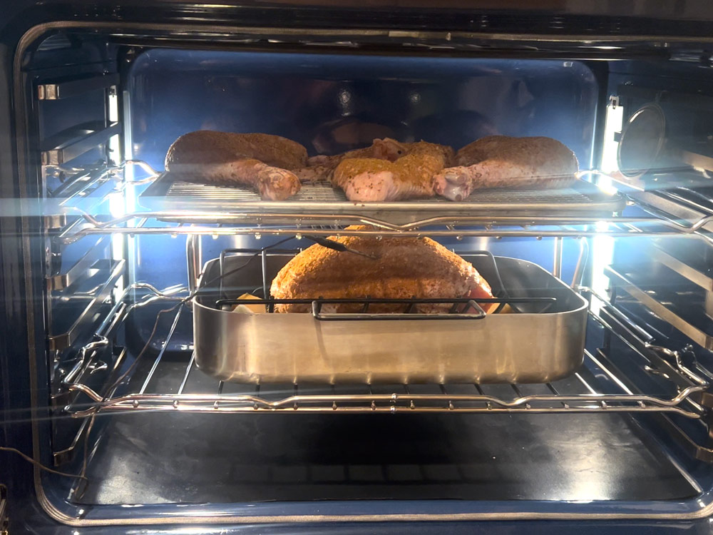 Place roasting rack with chicken breast on lower rack, and dark meat on upper rack of oven