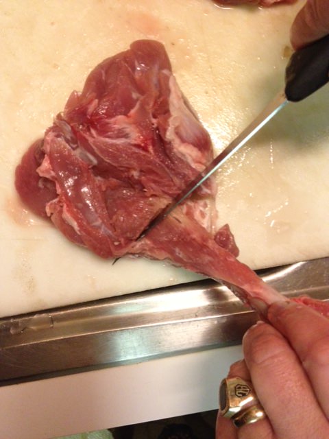 Scrape knife against bone to cut meat