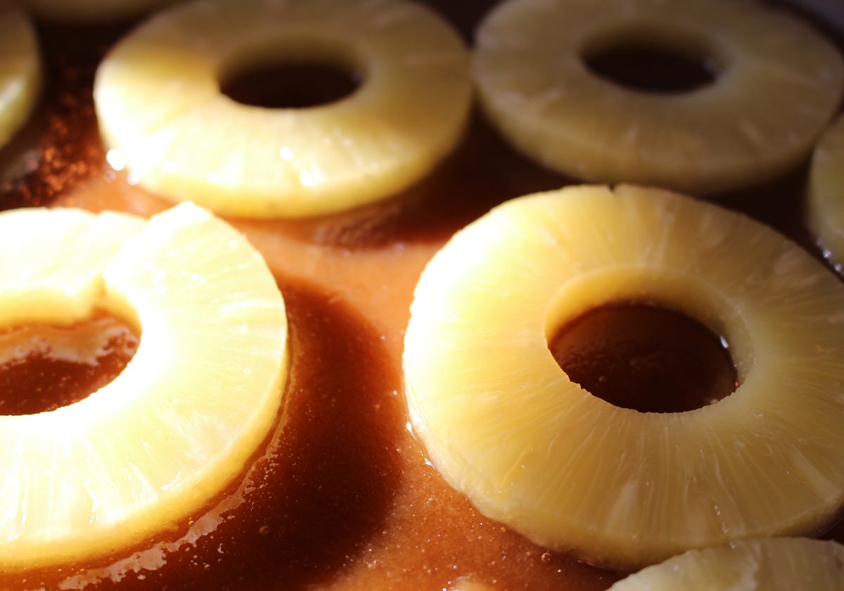 Arrange pineapple slices over brown sugar