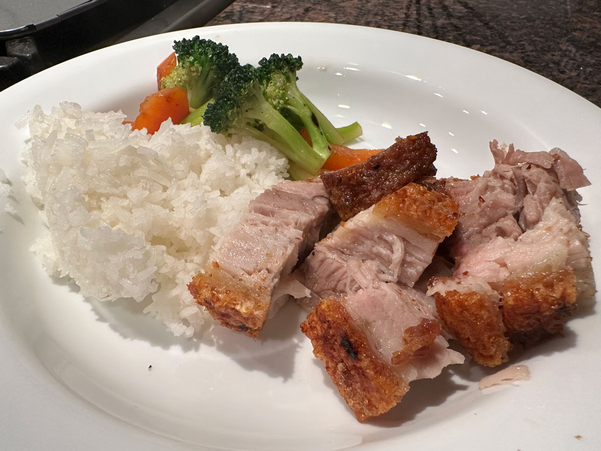 Roast pork belly served simply with rice and veggies.