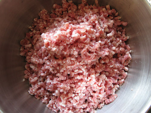 Grind pork through coarse plate of grinder