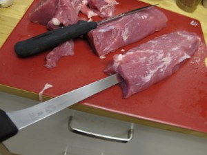 Using a long thin blade, work the knife into the end of the tenderloin