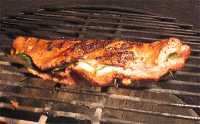 Pork tenderloin cooking on grill