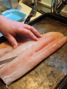 Make a single slice down the length of the fish without cutting all the way through