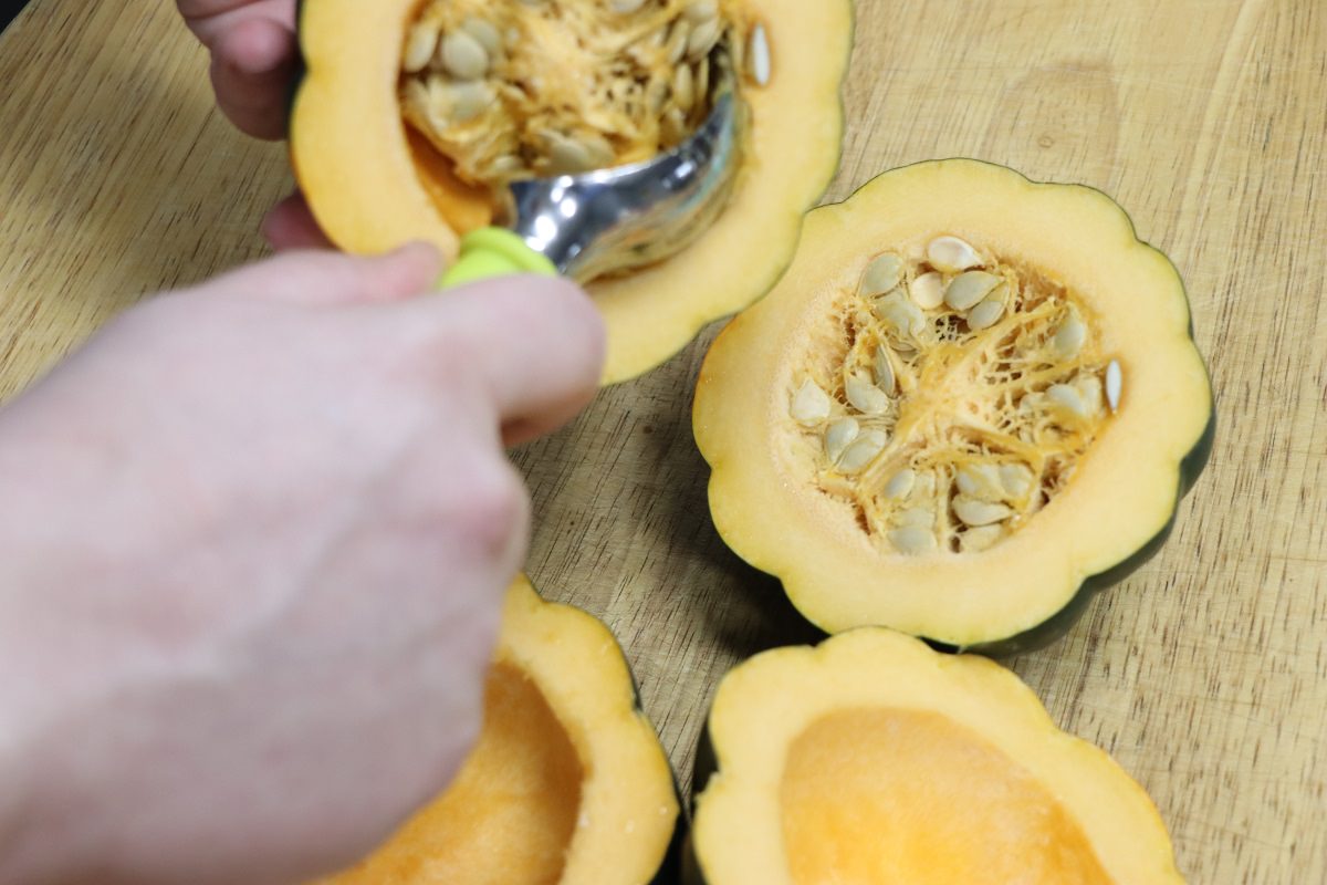 Halve acorn squash and scoop out seeds