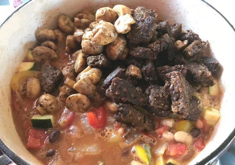 Add browned mushrooms and veggie burger pieces