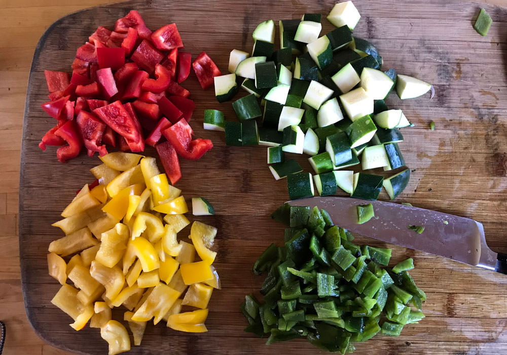 Dice zucchini and peppers into large pieces, from 3/4 to 1 inch