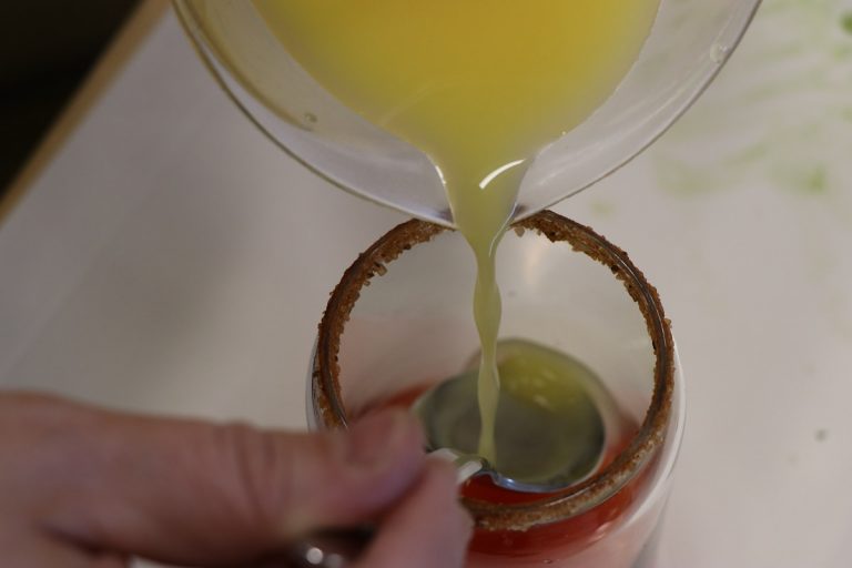 Shake ice, juices and vodka well