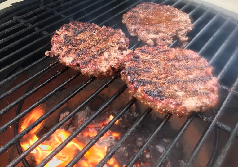 Grilled hamburgers - brown first side of burgers and flip