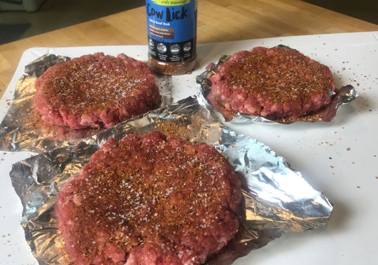 Grilled hamburgers - sprinkle burgers with Cow Lick seasoning